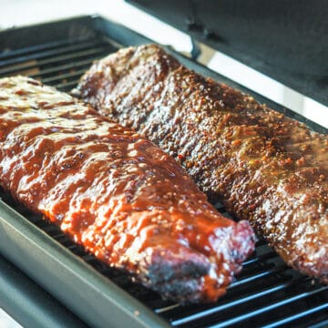 ribs with bbq sauce cooking on smoker