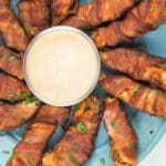 smoked jalapeno poppers on blue plate arranged in ring