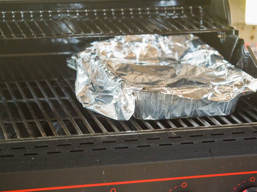 aluminum pan on grill covered with foil