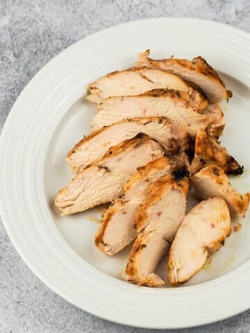 sliced grilled chicken on white plate