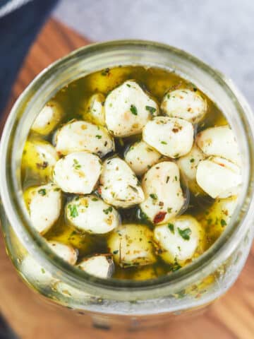 mozzarella pearls in olive oil with herbs and spices