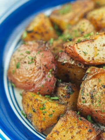 Roasted potatoes on plate.